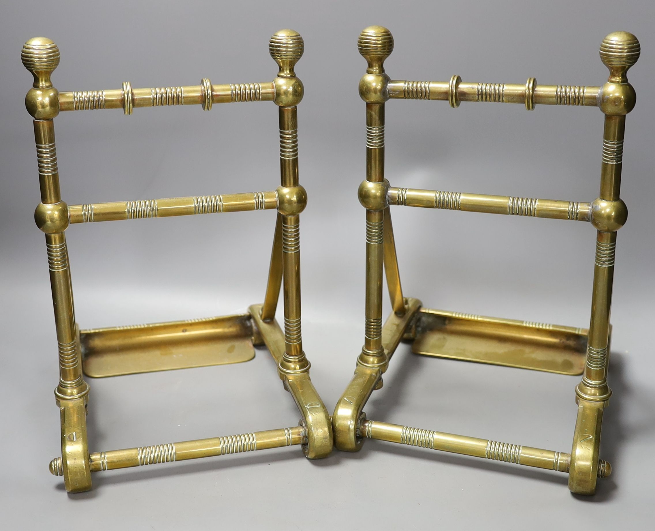 A pair of 19th century Dresser or Godwin style brass fire dogs